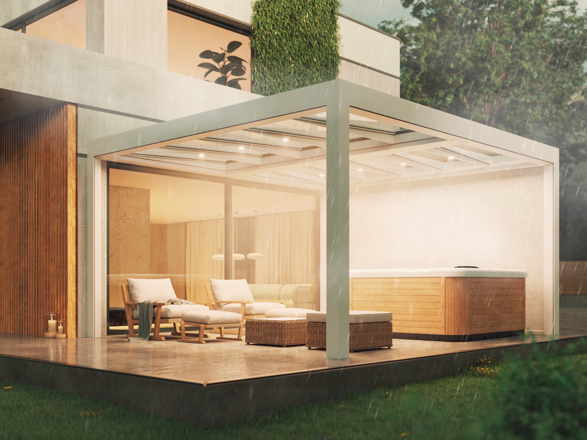 Aluminium B700‑pergola met glazen dak die een beschutte wellnesshoek met loungestoelen en jacuzzi biedt tijdens regen in een warme avondsfeer